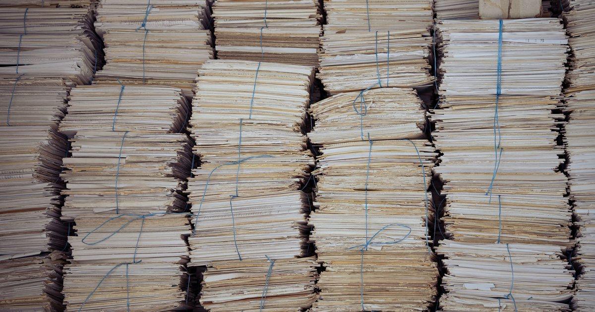 Stacks of paper records bound with blue string